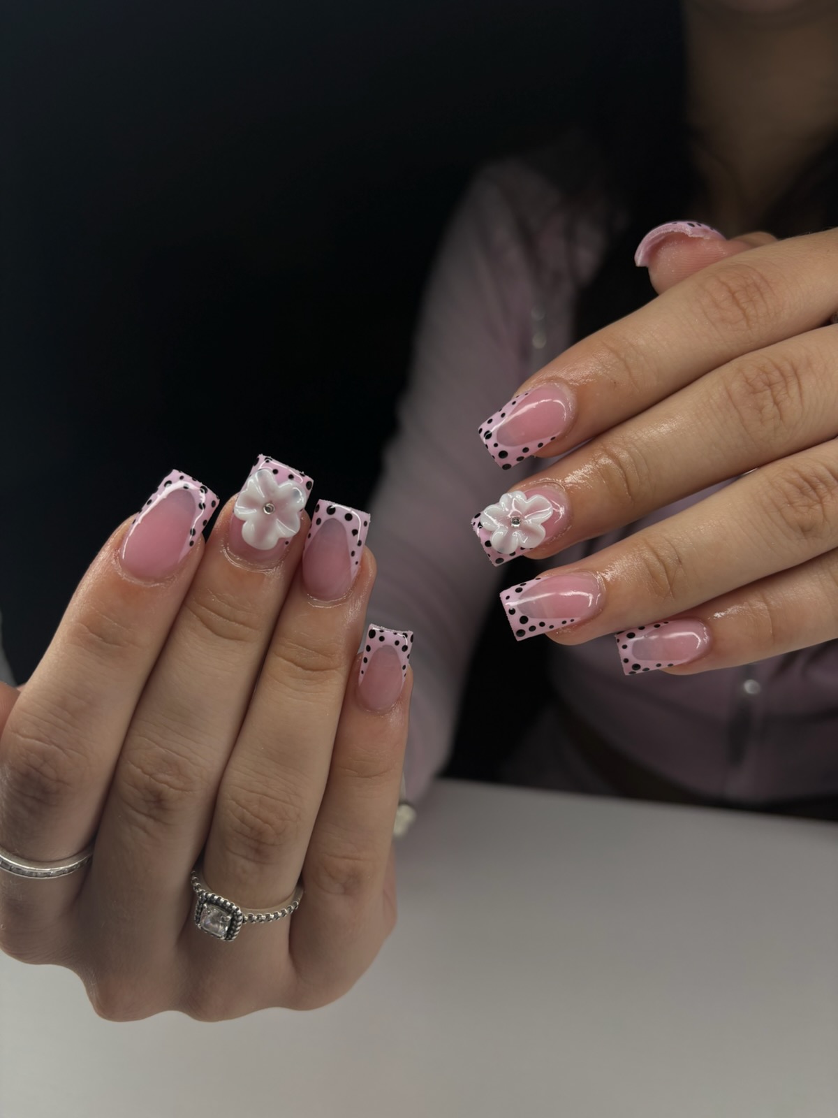 Pink French tip nails with polka dots and 3D flowers by Clawz By Juliee
